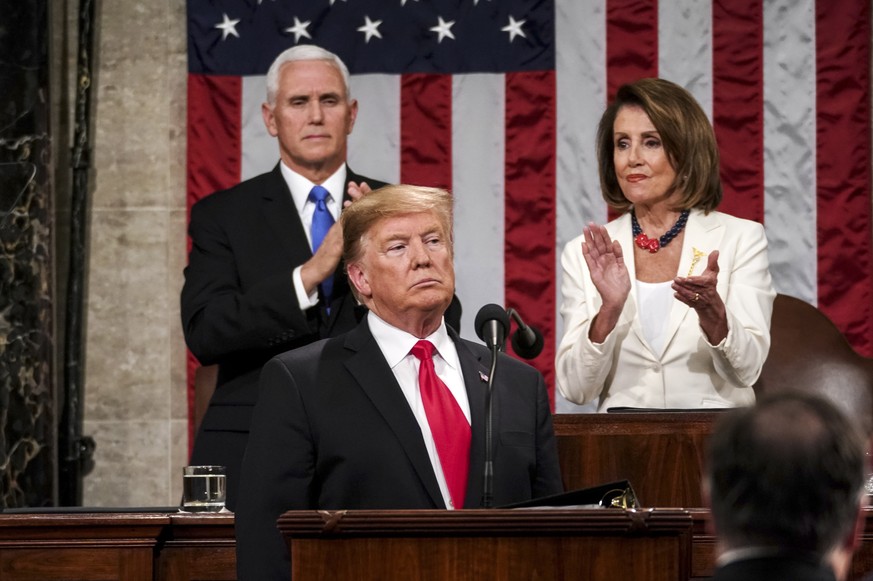 epa07346699 US President Donald J. Trump (C) delivers the State of the Union address, with Vice President Mike Pence (L) and Speaker of the House Nancy Pelosi (R) at the Capitol in Washington, DC, USA ...