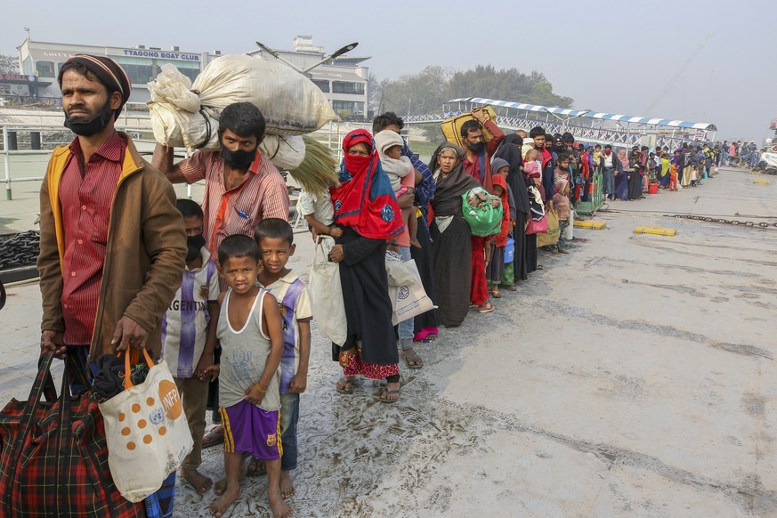 Rohingya refugees headed to the Bhasan Char island prepare to board navy vessels from the south eastern port city of Chattogram, Bangladesh, Monday, Feb.15,2021. Authorities sent a fourth group of Roh ...