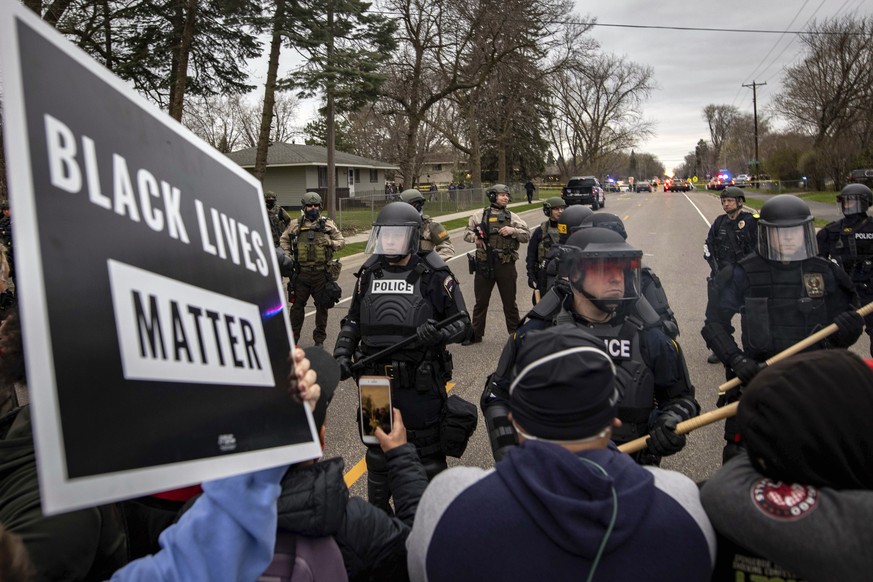 Protesters clash with police, Sunday, April 11, 2021, in Brooklyn Center, Minn. The family of Daunte Wright, 20, told a crowd that he was shot by police Sunday before getting back into his car and dri ...