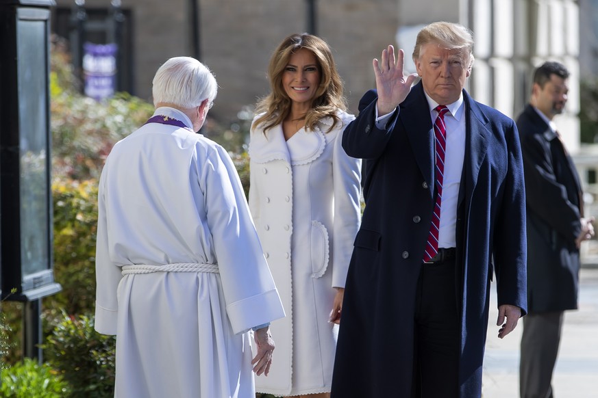 epa07445082 US President Donald J. Trump (R) and First Lady Melania Trump (C) are greeted by Reverend W. Bruce McPherson (L) as they attend services at St. John&#039;s Episcopal Church in Washington,  ...