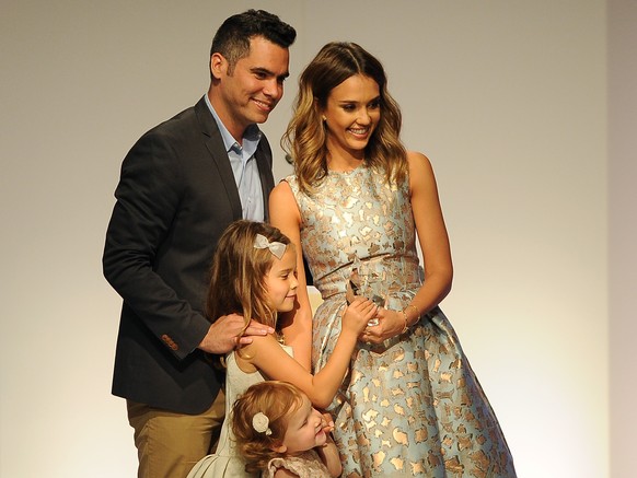 Actress Jessica Alba poses for photographers with her husband Cash Warren and their daughters Honor Marie, second left, and Haven Garner after Alba picked up a Mother of the Year award at the 85th Hel ...