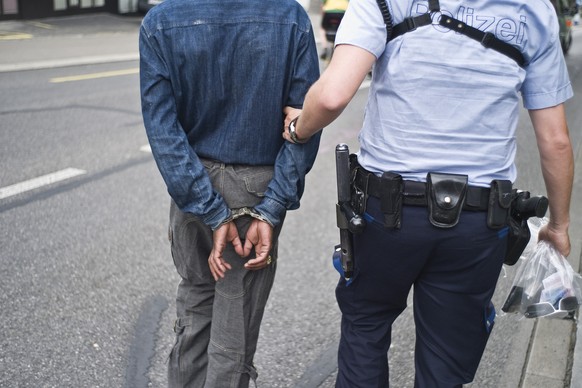 A municipal police officer of Zurich&#039;s special unit SOKO Uno 44 arrests a man who is not allowed to stay in the canton of Zurich, pictured on May 30, 2008 in Zurich, Switzerland. The SOKO Uno 44& ...