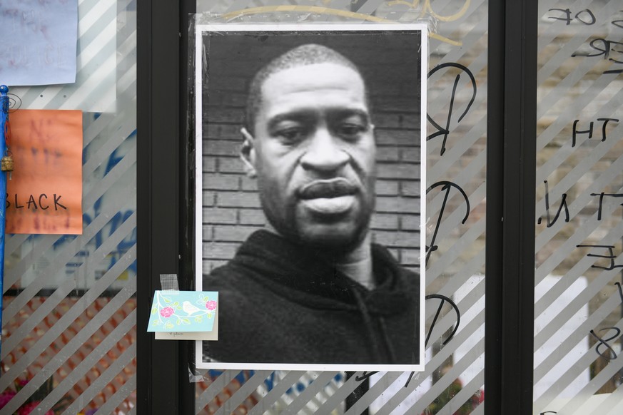epa08453025 An image of George Floyd is on display at a makeshift memorial near the scene of the arrest of Floyd who died in police custody in Minneapolis, Minnesota USA, 29 May 2020. Floyd&#039;s lif ...