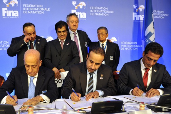 Front from left, President of International Swimming Federation, FINA, Julio Maglione, General Secretary of the Qatari Olympic Committee Thani Abdulrahman Al-Kuwari and President of the Qatari Swimmin ...