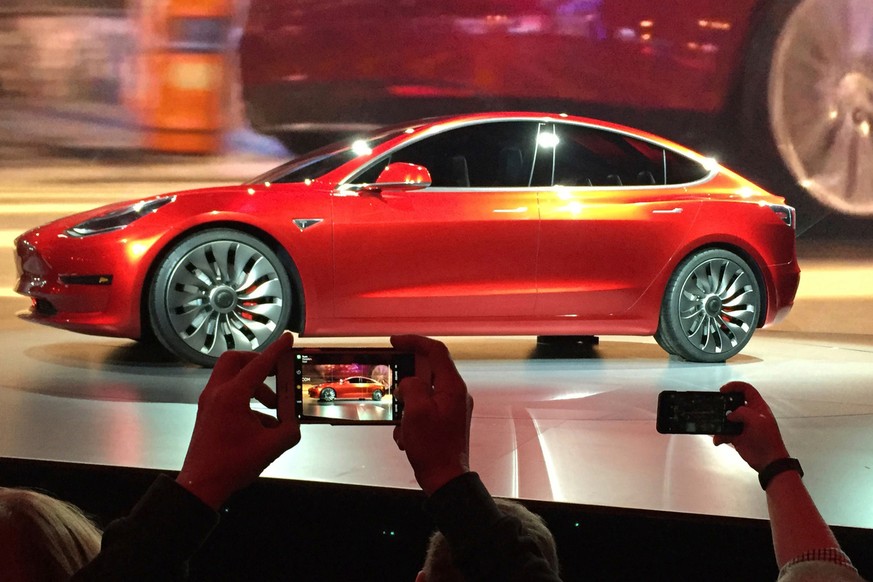 FILE- In this March 31, 2016, file photo, Tesla Motors unveils the new lower-priced Model 3 sedan at the Tesla Motors design studio in Hawthorne, Calif. Electric car maker Tesla Inc. increased product ...