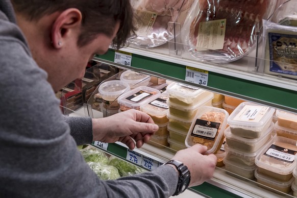 A worker removes expired food in a local supermarket in Brussels on Monday, Jan. 16, 2017. The European Court of Auditors has chided the European Union&#039;s executive branch in a report, &quot;Comba ...