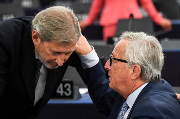 epa07014183 EU Commissioner for European Neighborhood Policy and Enlargement Johannes Hahn (L) speaks with Jean-Claude Juncker (R), President of the European Commission, before the annual State of The ...