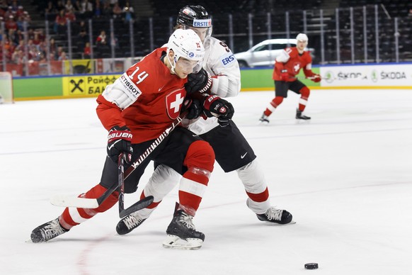 Switzerland&#039;s forward Chris Baltisberger, left, vies for the puck with Austria&#039;s forward Alexander Rauchenwald, right, during the IIHF 2018 World Championship preliminary round game between  ...