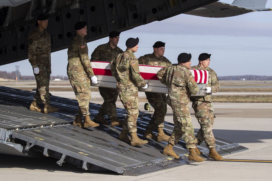FILE - In this Dec. 25, 2019, file photo, an Army carry team moves a transfer case containing the remains of U.S. Army Sgt. 1st Class Michael Goble, at Dover Air Force Base, Del.. Goble, a U.S. Specia ...