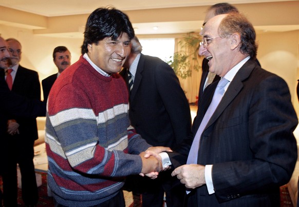 Bolivian President-elect Evo Morales, left, is welcomed by Chairman and CEO of the Spanish-Argentine Repsol YPF SA oil company Antonio Brufau, right, ahead of their meeting in Madrid in this Jan. 4, 2 ...