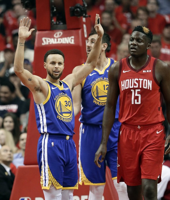 Golden State Warriors&#039; Stephen Curry (30) holds his hands up after being charged with a foul as Houston Rockets center Clint Capela (15) walks away during the first half in Game 6 of a second-rou ...