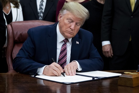 epa08025516 US President Donald J. Trump signs &#039;H.R. 724, the Preventing Animal Cruelty and Torture Act&#039;, in the Oval Office of the White House in Washington, DC, USA, 25 November 2019. EPA/ ...