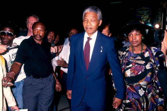 A photo dated 27 February 1990 of former South African President Nelson Mandela and his second wife, Winnie Mandela at Johannesburg International airport, South Africa, before their departure for a tr ...