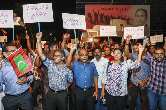 In this late Sunday, Feb.4, 2018 photo, Maldivian opposition supporters shout slogans during a protest as they the urge the government to obey a Supreme Court order to release and retry political pris ...