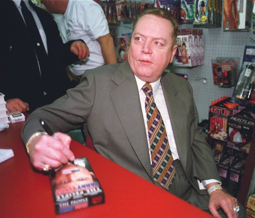 FILE - &quot;Hustler&quot; Magazine publisher Larry Flynt signs a copy of &quot;The People Vs. Larry Flynt&quot; in his downtown Cincinnati &quot;Hustler&quot; store on April 30, 1998. Flynt, who turn ...