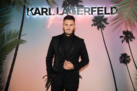 epa07065246 French model and singer Baptiste Giabiconi celebrates the launch of the Karl x Kaia collaboration capsule collection during the Paris Fashion Week, in Paris, France, 02 October 2018. The p ...