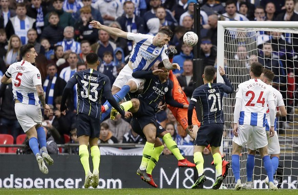 Brighton&#039;s Shane Duffy, center, jumps for a header during the English FA Cup semifinal soccer match between Manchester City and Brighton &amp; Hove Albion at Wembley Stadium in London, Saturday,  ...