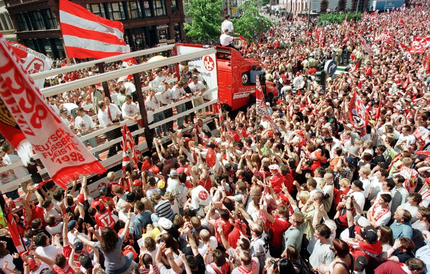 Thousands of fans surround the truck carrying the players of German 1998 soccer champion 1.FC Kaiserslautern during the official celebration in Kaiserslautern, Germany, on Sunday May 10, 1998. (AP Pho ...
