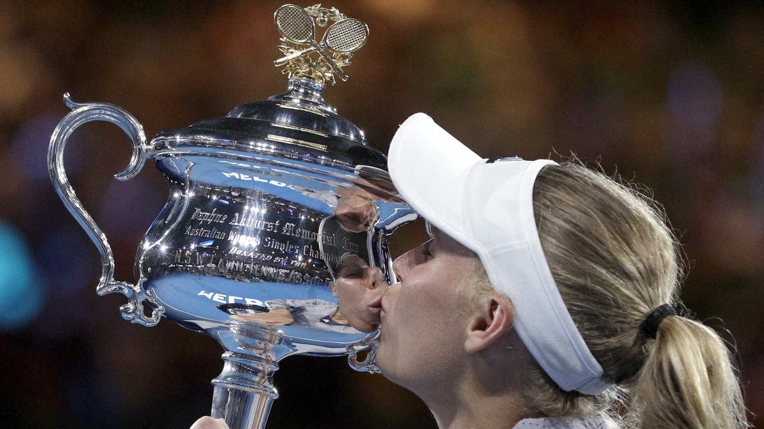 Denmark&#039;s Caroline Wozniacki kisses her trophy after defeating Romania&#039;s Simona Halep in the women&#039;s singles final at the Australian Open tennis championships in Melbourne, Australia, S ...