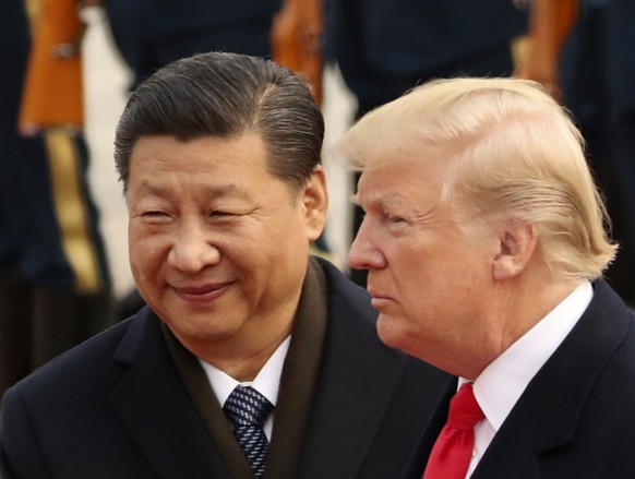 FILE - In this Nov. 9, 2017, file photo, U.S. President Donald Trump and Chinese President Xi Jinping participate in a welcome ceremony at the Great Hall of the People in Beijing, China. Trump is to m ...