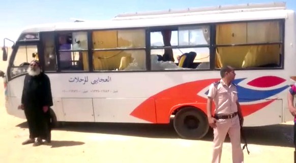 epa05991662 Security officials stand at the site of an armed attack on a bus near the Monastery of St Samuel the Confessor, in Minya Province, central Egypt, 26 May 2017. According to news reports, a  ...