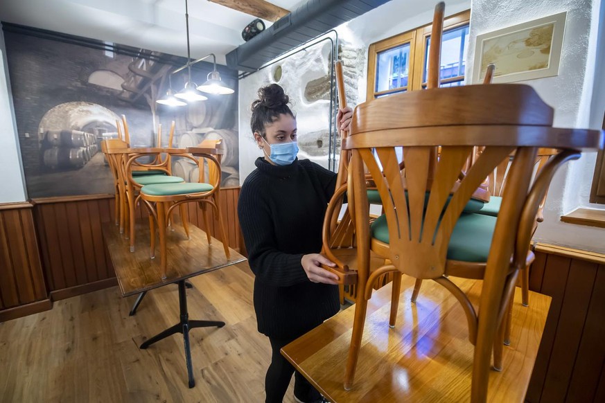 Une serveuse range les chaises dans le Restaurant Le Maitre Jaques avant sa fermeture, lors de la crise du Coronavirus (Covid-19), ce mercredi 4 novembre 2020 a Nyon. Le canton de Vaud durcit a son to ...