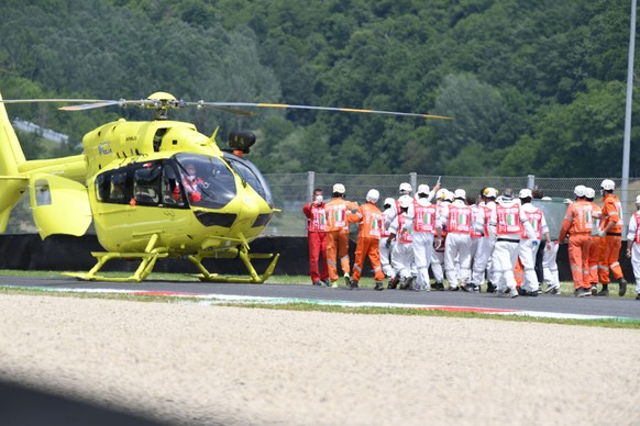 epa09235010 Swiss Jason Dupasquier of Moto3 receives medical assistance after crashing during the qualifying session of the Motorcycling Grand Prix of Italy at the Mugello circuit in Scarperia, centra ...