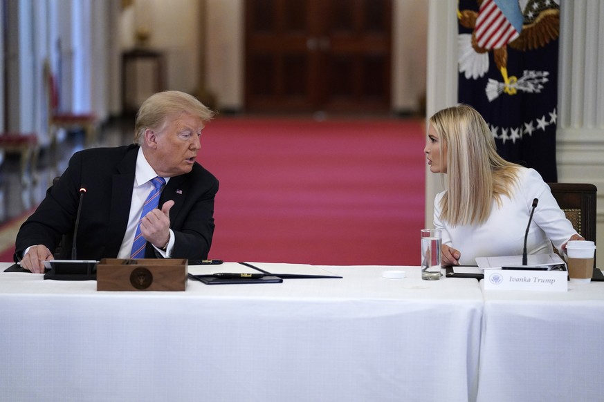President Donald Trump speaks with Ivanka Trump during a meeting with the American Workforce Policy Advisory Board, in the East Room of the White House, Friday, June 26, 2020, in Washington. (AP Photo ...