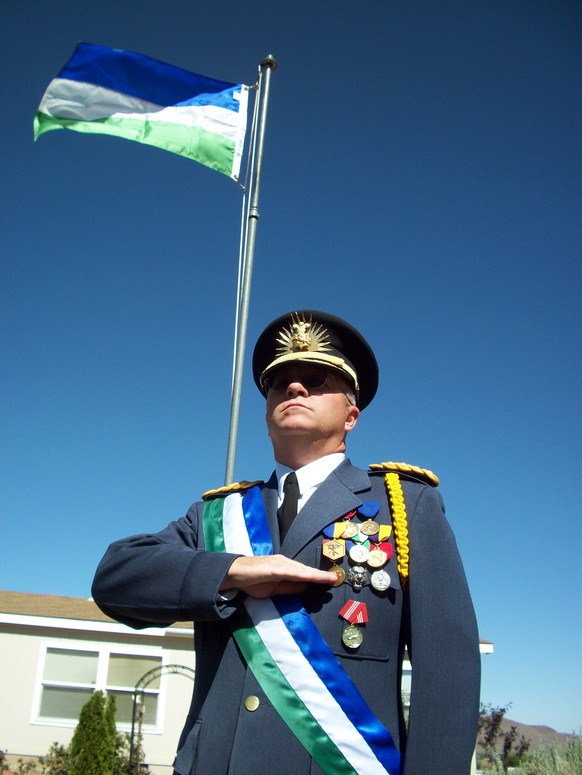 This undated photo provided by Kevin Baugh on April 10, 2015 shows him in a uniform on his 1.3-acres of land he calls the Republic of Molossia, east of Reno, Nev. On Saturday, April 11, 2015, Baugh pl ...