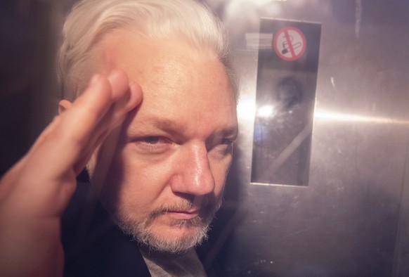 epa08008241 (FILE) - Wikileaks co-founder Julian Assange, in a prison van, as he leaves Southwark Crown Court in London, Britain, 01 May 2019 (reissued 19 November 2019). Sweden prosecutors on 19 Nove ...
