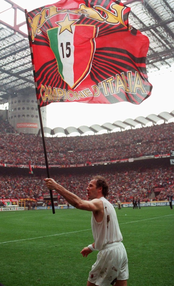 AC Milan&#039;s captain Franco Baresi carries a flag with the 15 scudetti (Italian league titles) of AC Milan at Milan&#039;s San Siro stadium on Sunday, April 28, 1996. Baresi, who redifined the swee ...