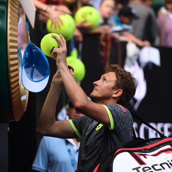 epa05729944 Denis Istomin signs autographs after defeating Novak Djokovic of Serbia in round two of the Mens Singles at the Australian Open Grand Slam tennis tournament in Melbourne, Victoria, Austra ...