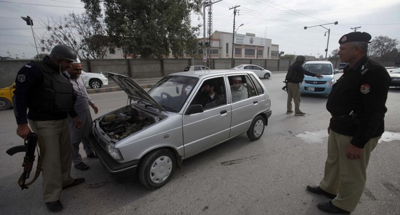 epa05799216 Pakistani security officials check a vehicle at checkpoint as security has been intensified across the country after suicide bombing at the shrine of Sufi Muslim Saint Lal Shahbaz Qalander ...