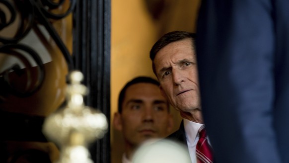 FILE - In this Dec. 21, 2016, file photo, retired Gen. Michael Flynn, a senior adviser to then-President-elect Donald Trump listens as Trump speaks to members of the media at Mar-a-Lago, in Palm Beach ...