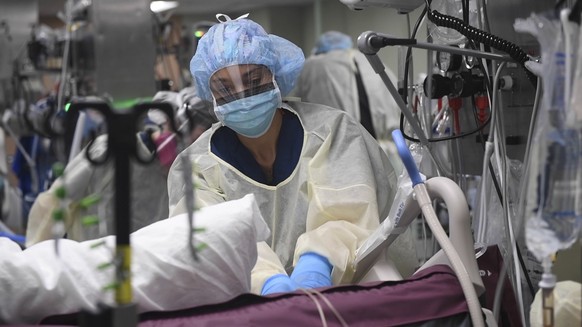epa08385061 A handout photo made available by the US Navy shows Lt. j.g. Natasha McClinton, an operating room (OR) nurse, preparing a patient for a procedure in the intensive care unit (ICU) aboard th ...