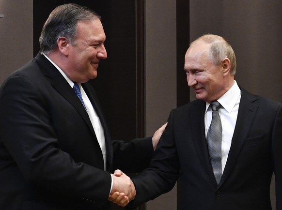 Russian President Vladimir Putin, right, and U.S. Secretary of State Mike Pompeo, greet each other prior to their talks in the Black Sea resort city of Sochi, southern Russia, Tuesday, May 14, 2019. P ...