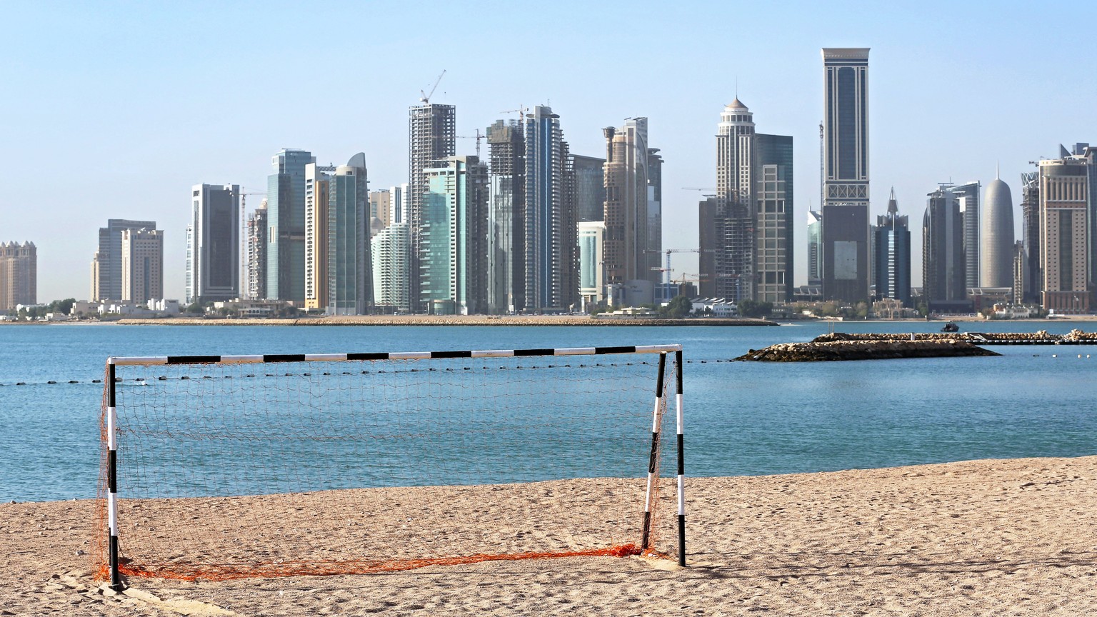 epa06052571 (FILE) - A football goal at a beach in front of the skyline of Doha, Qatar, 21 April 2015 (reissued on 27 June 2017). The report by then FIFA chief ethics investigator Michael J. Garcia on ...