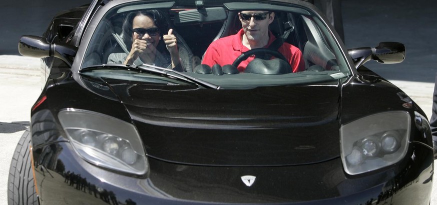 U.S. Secretary of State Condoleezza Rice, left, gives a thumbs up as she prepares to take a test ride on the 2007 Tesla Roadster electric car along with Tesla sales manager Tom O&#039;Leary, right, du ...