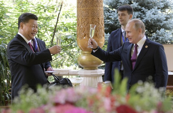 CAPTION CORRECTIONS CORRECTS DATE: Russian President Vladimir Putin, right, toasts with Chinese President Xi Jinping prior to the Conference on Interaction and Confidence Building Measures in Asia (CI ...