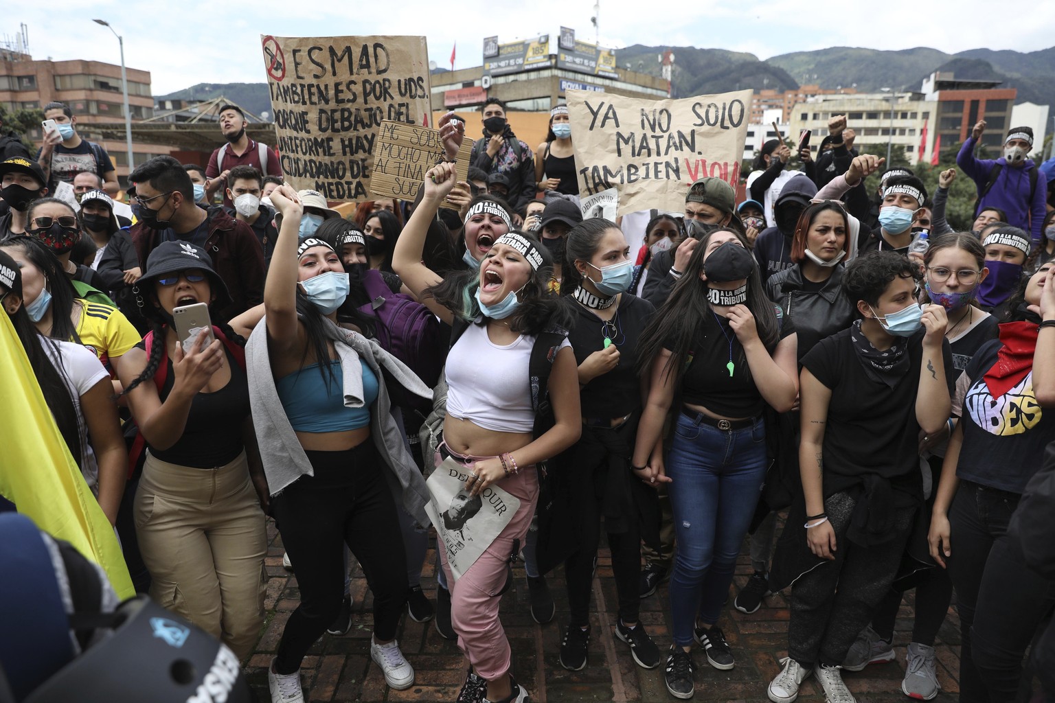 Women shout slogans during a demonstration against government-proposed tax reform, marking May Day, or International Workers&#039; Day, in Bogota, Colombia, Saturday, May 1, 2021, amid the new coronav ...