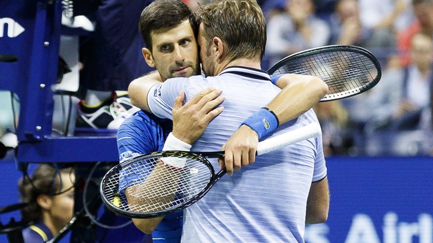 epa07811916 Novak Djokovic (L) of Serbia embraces Stan Wawrinka (R) of Switzerland after Djokovic retired in the third set during a match on the seventh day of the US Open Tennis Championships the UST ...