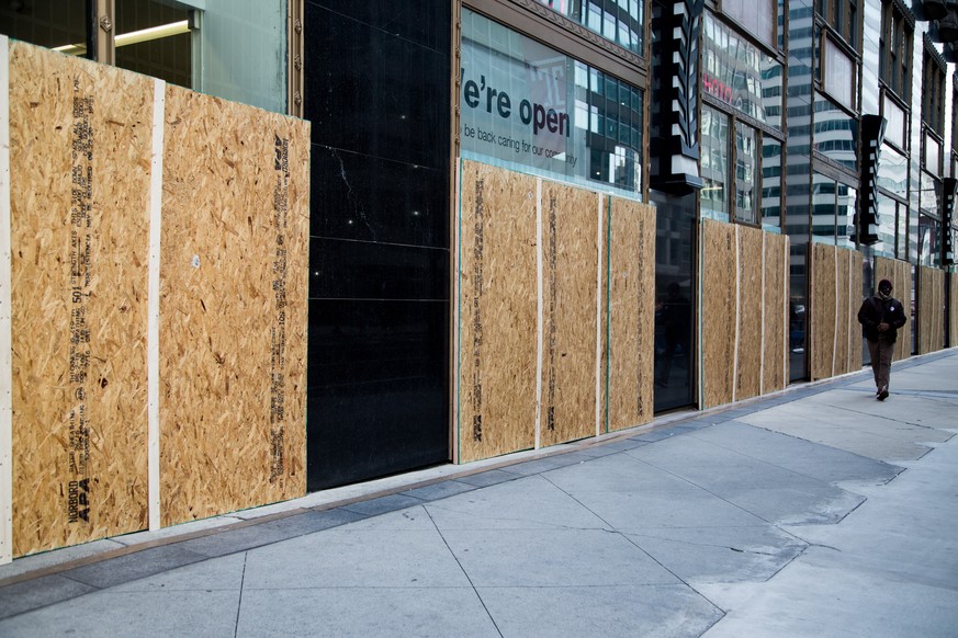 epa08797035 Plywood boards are installed in front of store windows as a precaution against potential damage from election related protests in Philadelphia, Pennsylvania, USA, 03 November 2020. America ...