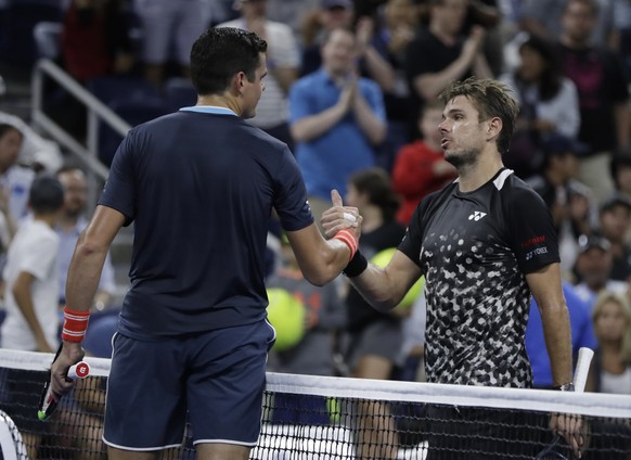 Milos Raonic, left, of Canada, shakes hands with Stan Wawrinka, of Switzerland, after Raonic won their third-round match at the U.S. Open tennis tournament, Friday, Aug. 31, 2018, in New York. (AP Pho ...