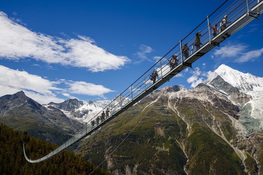 People walk on the &quot;Europabruecke&quot;, that is supposed to be the world&#039;s longest pedestrian suspension bridge with a length of 494m, after the official inauguration of the construction in ...