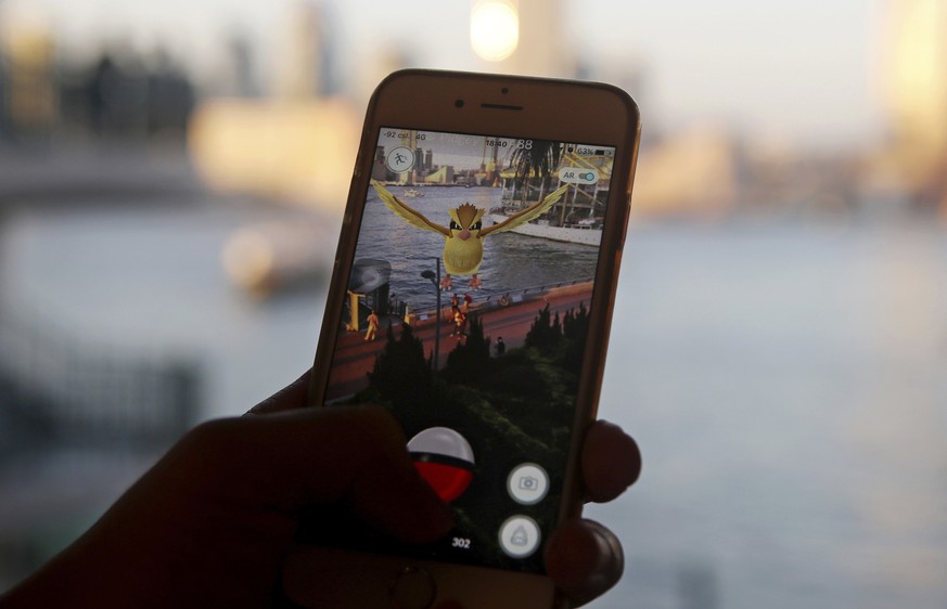 FILE - In this July 25, 2016, file photo, a fan maneuvers his smartphone as he plays &quot;Pokemon Go&quot; in Hong Kong. &quot;Pokemon Go&quot; is among Google&#039;s most-trending searches of 2016.  ...