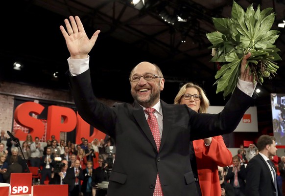 New elected chairman and top candidate for the upcoming general election Martin Schulz, waves during an extraordinary convention of the German Social Democratic party, SPD, in Berlin, Germany, Sunday, ...