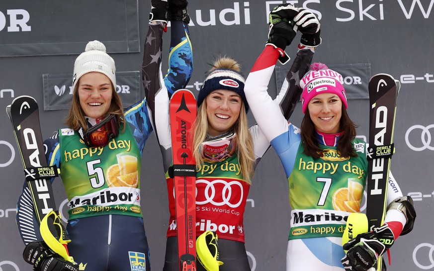 United States&#039; Mikaela Shiffrin, center, winner of an alpine ski, women&#039;s World Cup slalom, celebrates on the podium with second-placed Sweden&#039;s Anna Swenn Larsson, left, and third-plac ...