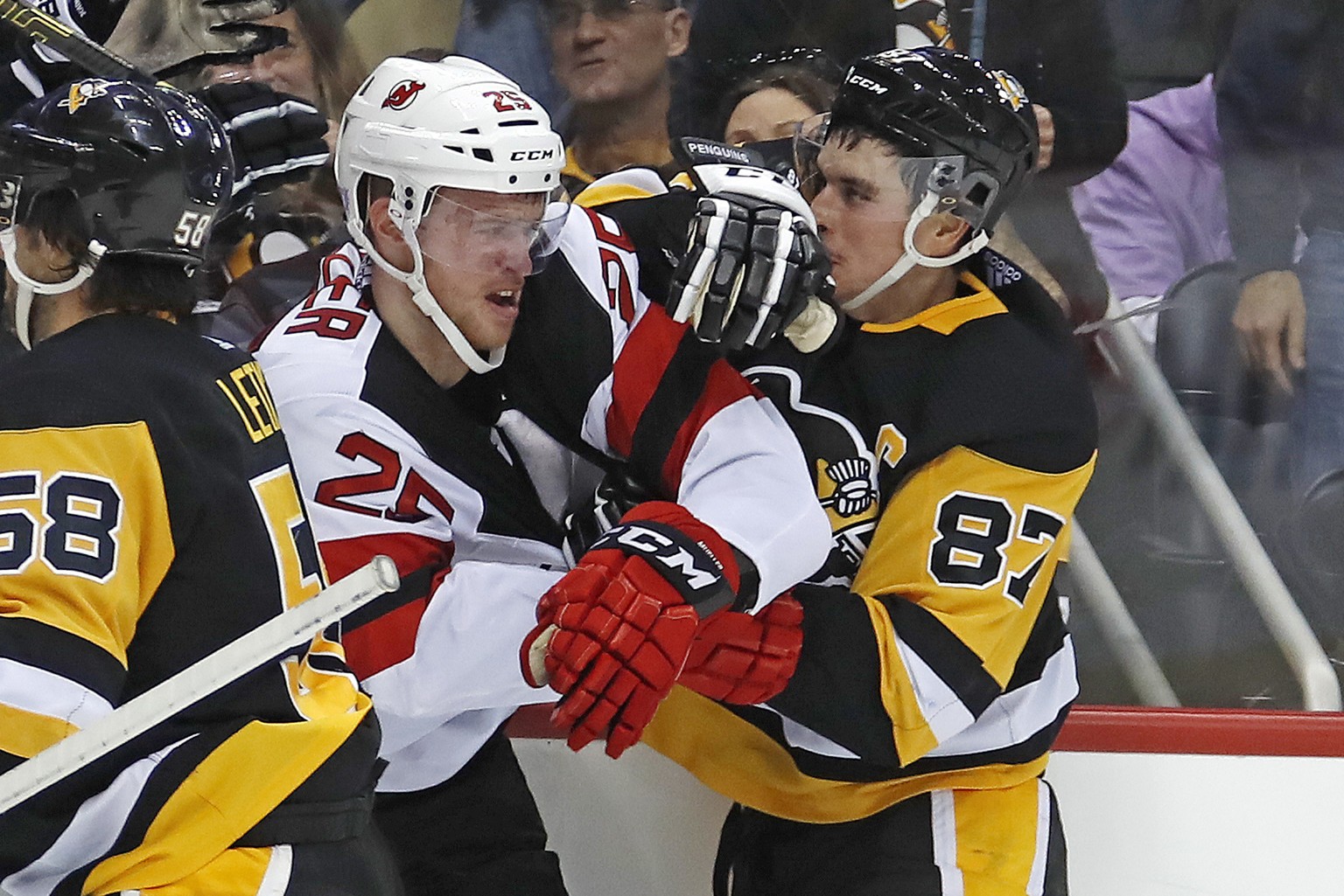 Pittsburgh Penguins&#039; Sidney Crosby (87) and Mirco Mueller (25) fight during the second period of an NHL hockey game in Pittsburgh, Monday, Nov. 5, 2018. (AP Photo/Gene J. Puskar)
