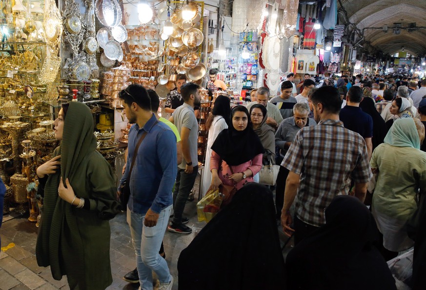 epa07670654 Iranians go shopping in the old grand bazaar in Tehran, Iran, 24 June 2019. Iranian media has reported that as Iranians suffer from the sanctions and economic crisis which has affected the ...