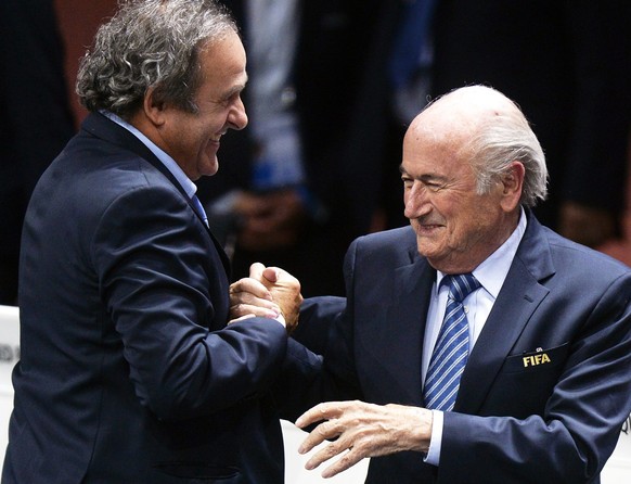 epa05031130 (FILE) A file picture dated 29 May 2015 of FIFA President Joseph Blatter (R) being congratulated by UEFA President Michel Platini (L) after his election as FIFA president during the 65th F ...
